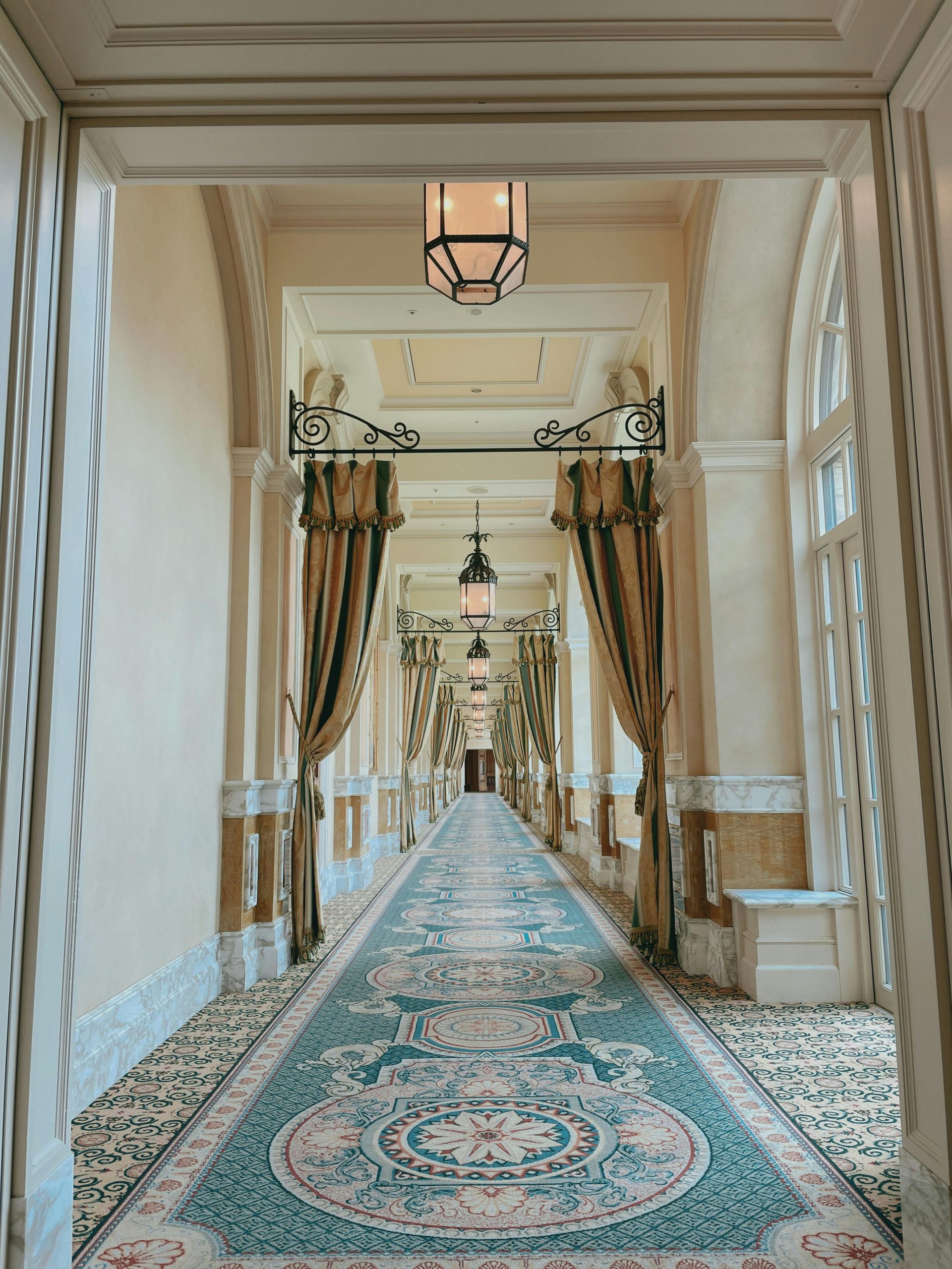 Luxurious indoor hallway featuring ornate design elements and elegant drapery.